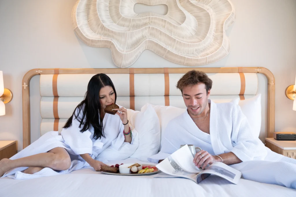 A couple enjoys breakfast in bed at a luxury la jolla boutique hotel.
