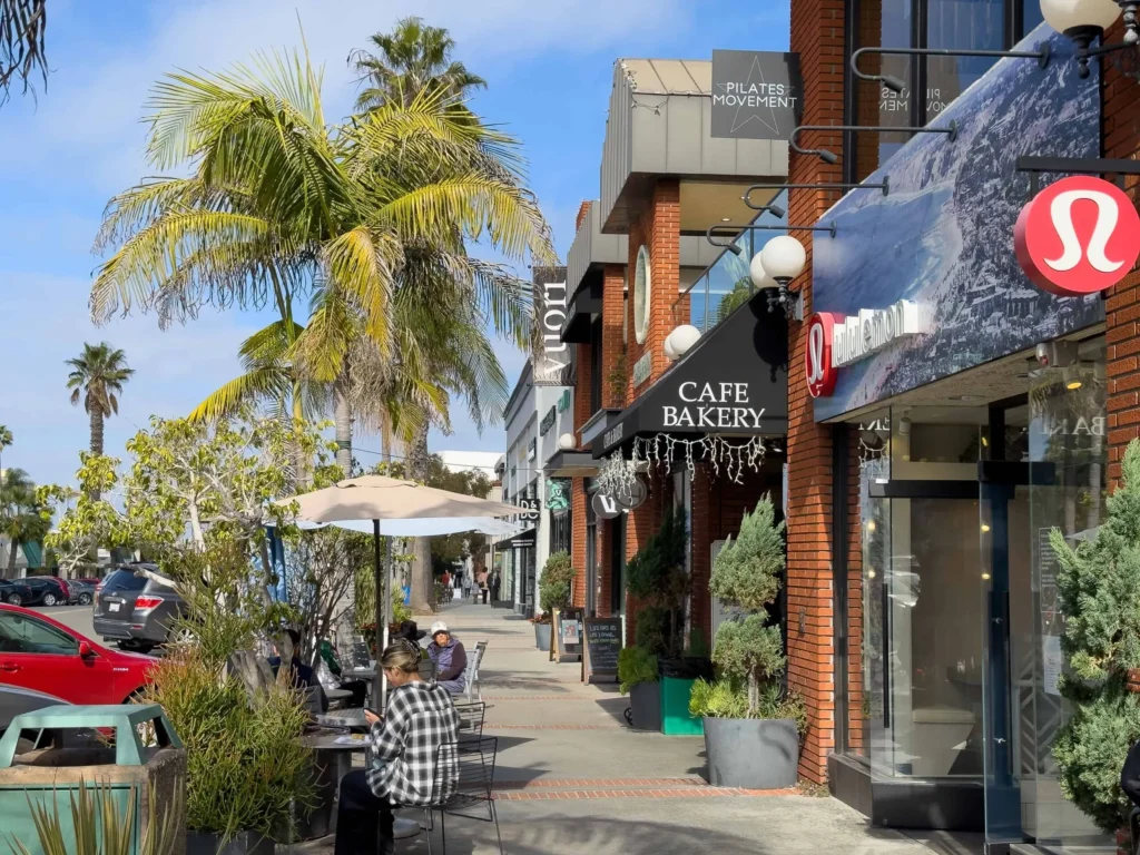 Pedestrians enjoy a sunny day visiting local shops and finding things to do in La Jolla.